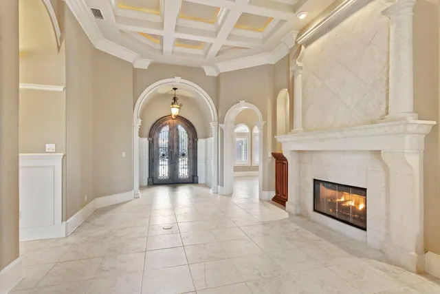 a view of a livingroom with a chandelier fan windows and a chandelier