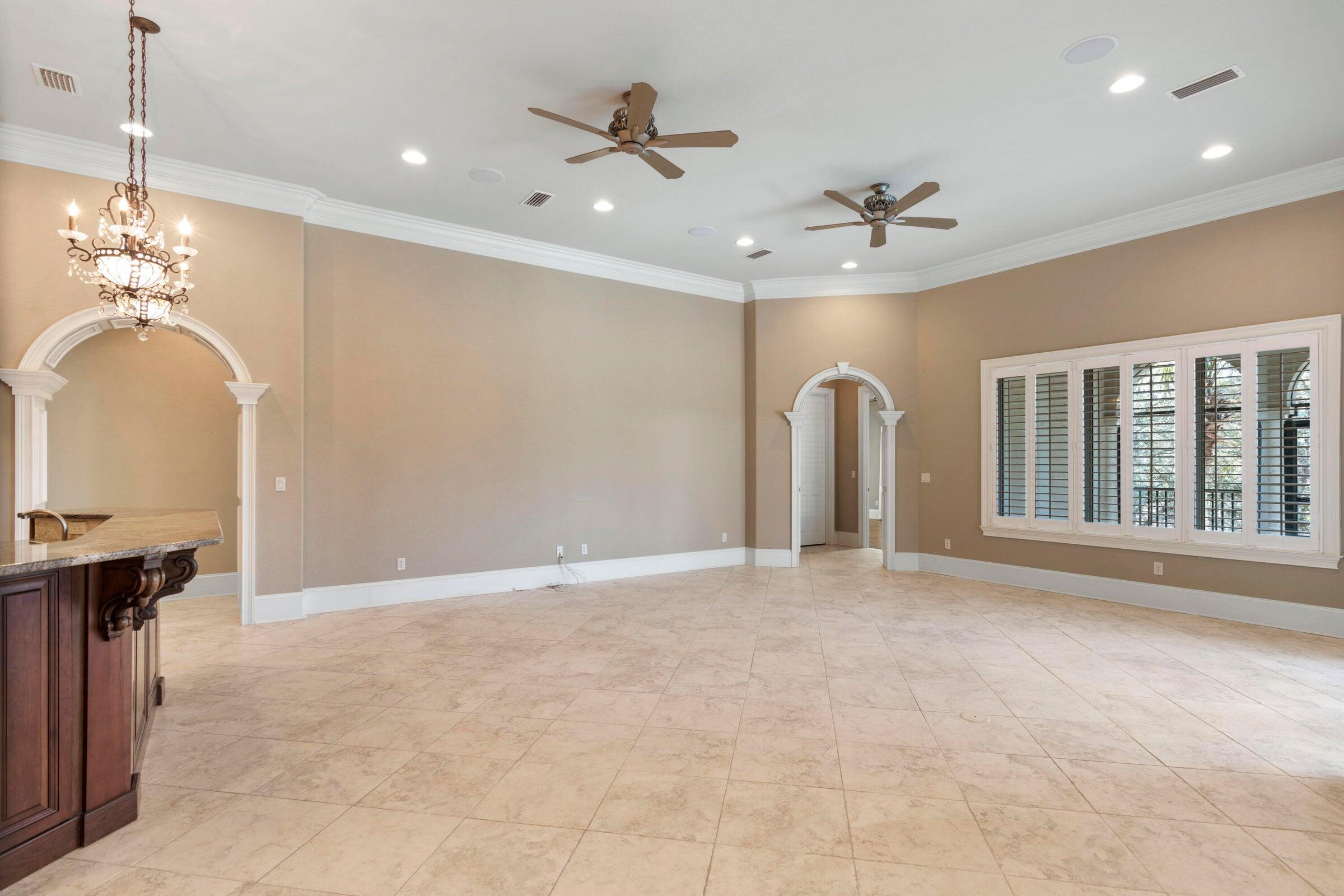 322 Emerald Ridge Santa Rosa Beach, FL 32459 - Photo 9 of 43 a view of a livingroom with a chandelier fan windows and a chandelier