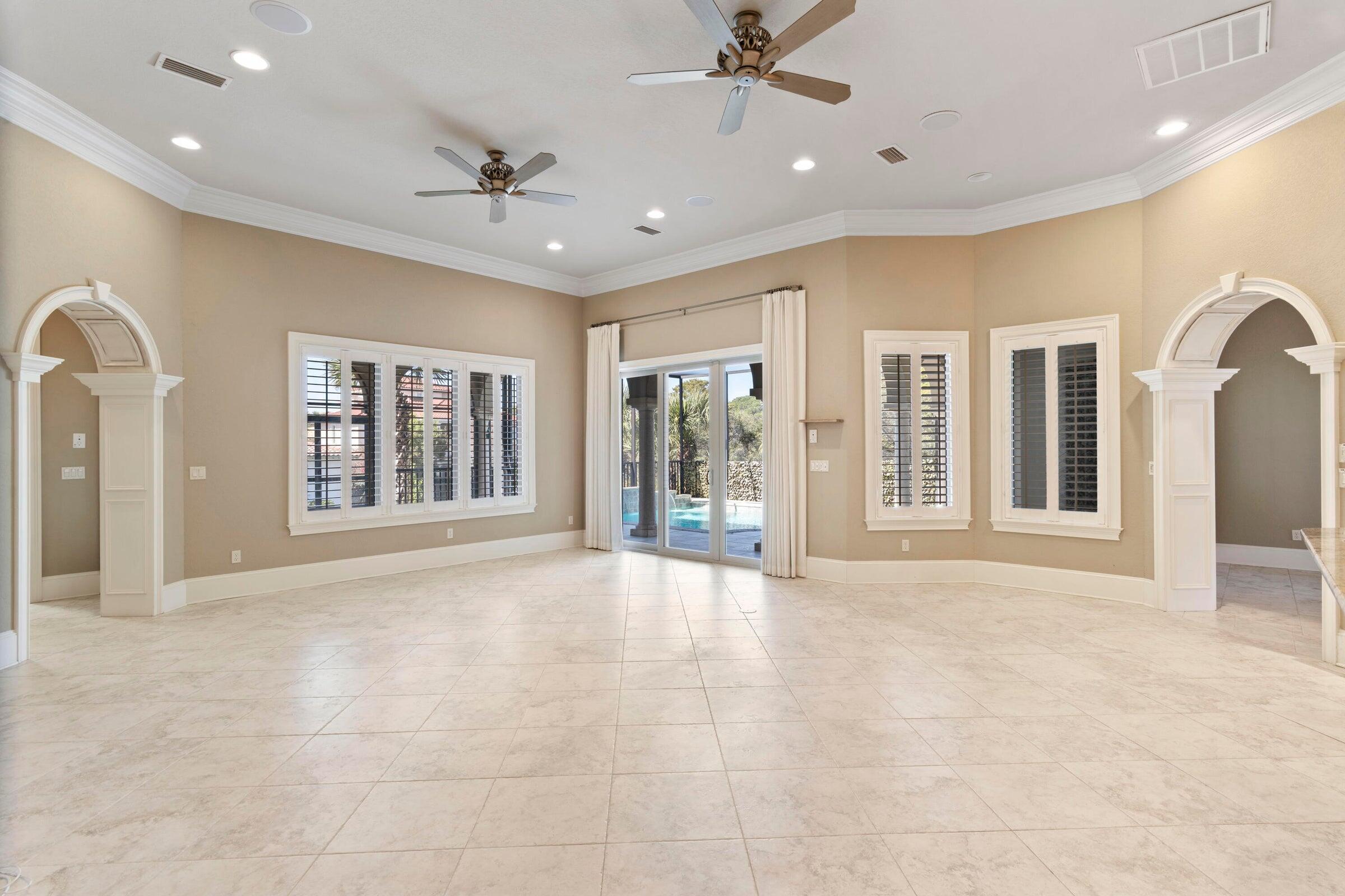 322 Emerald Ridge Santa Rosa Beach, FL 32459 - Photo 10 of 43 a view of an empty room with glass door and chandelier fan