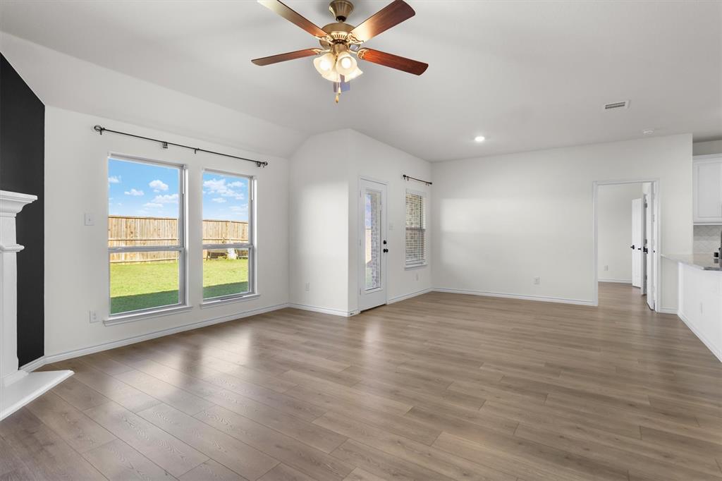 505 Maverick Street Anna, TX 75409 - Photo 15 of 39 a view of an empty room with a window and wooden floor