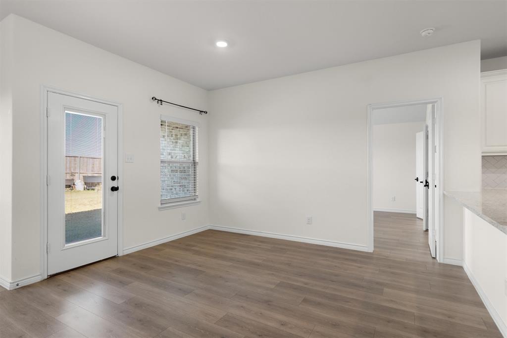 505 Maverick Street Anna, TX 75409 - Photo 17 of 39 a view of an empty room with wooden floor and a window