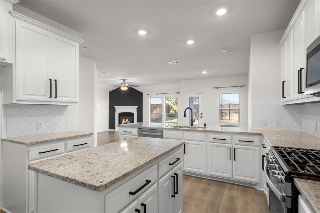 505 Maverick Street Anna, TX 75409 - Photo 24 of 39 a kitchen with a sink stove and cabinets