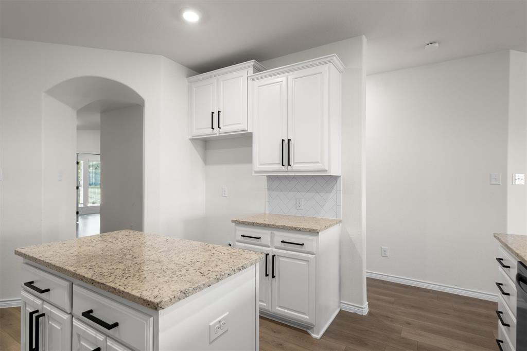 505 Maverick Street Anna, TX 75409 - Photo 25 of 39 a kitchen with stainless steel appliances granite countertop a stove and a sink