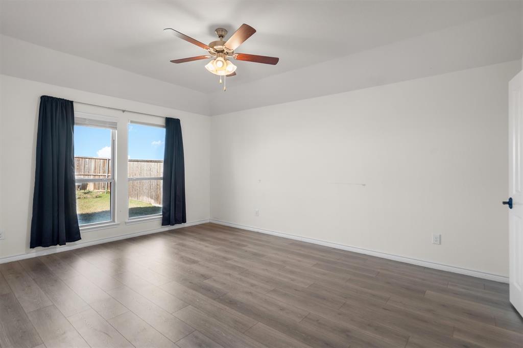 505 Maverick Street Anna, TX 75409 - Photo 27 of 39 a view of an empty room with a window and wooden floor