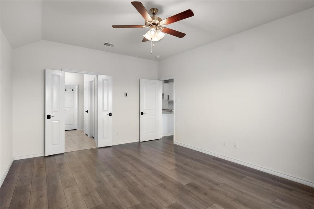 505 Maverick Street Anna, TX 75409 - Photo 29 of 39 an empty room with wooden floor and ceiling fan