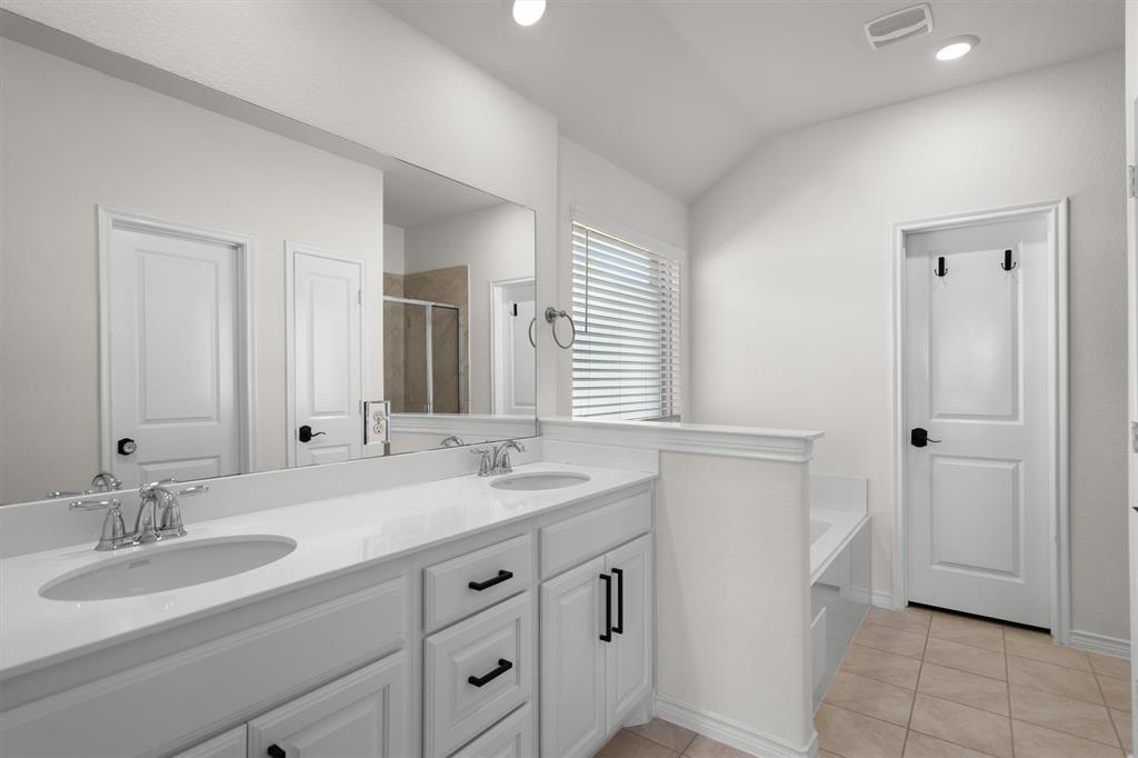 505 Maverick Street Anna, TX 75409 - Photo 30 of 39 a bathroom with a sink and a mirror