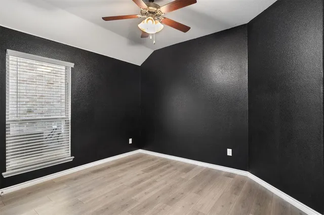 a view of a livingroom with a ceiling fan and window
