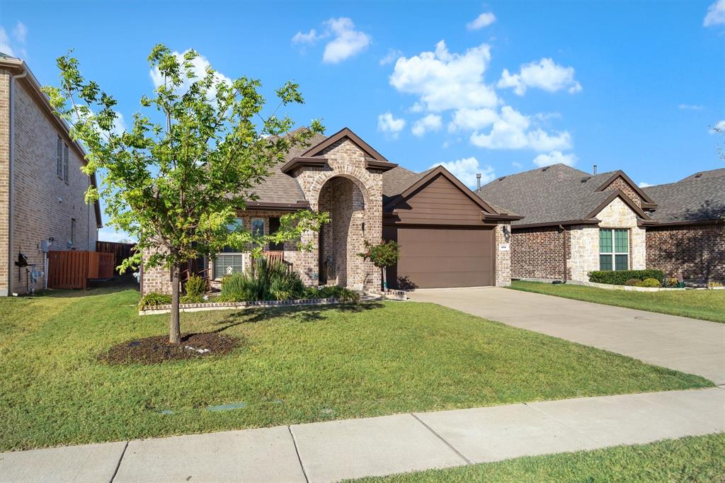 505 Maverick Street Anna, TX 75409 - Photo 7 of 39 a front view of a house with a garden