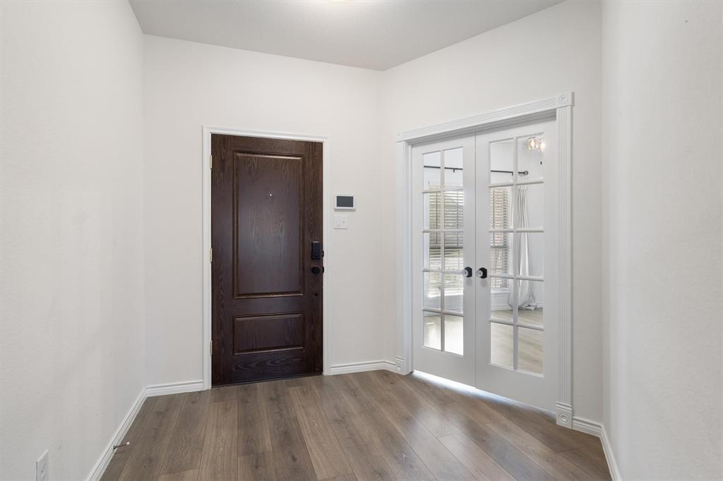 505 Maverick Street Anna, TX 75409 - Photo 9 of 39 a view of an empty room with wooden floor and closet