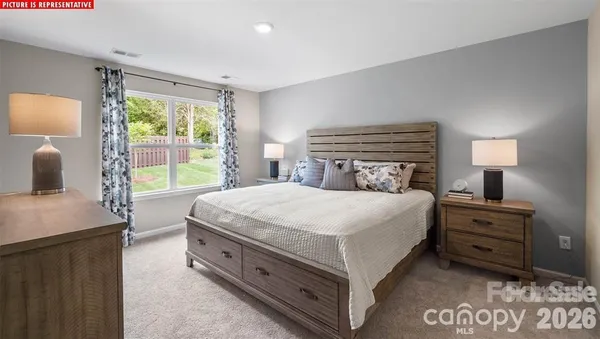 a bedroom with a bed and a night stand