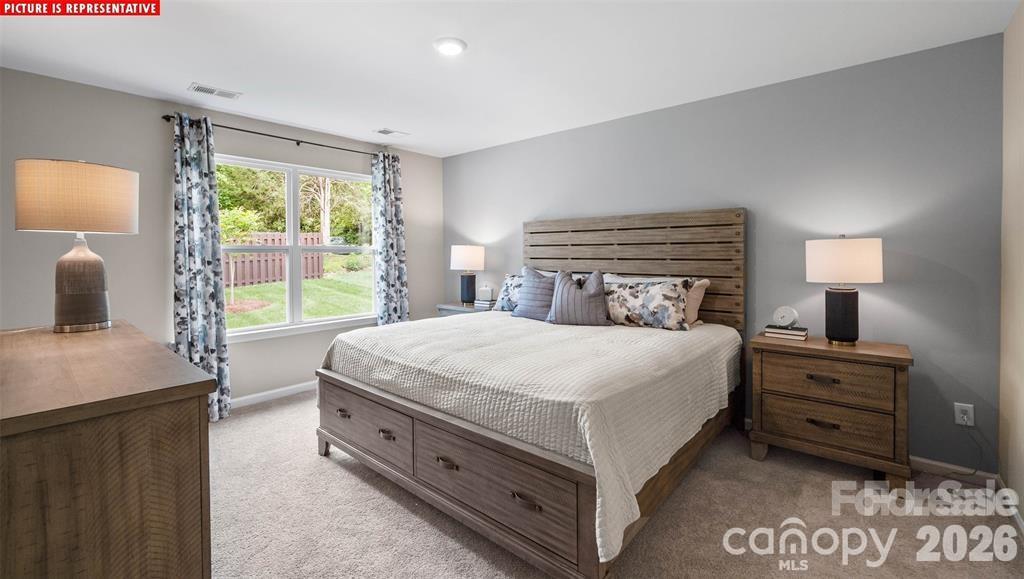 1700 Vanderlyn Street Monroe, NC 28112 - Photo 14 of 19 a bedroom with a bed and a night stand