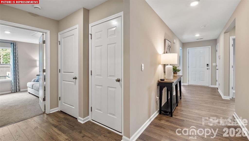 1700 Vanderlyn Street Monroe, NC 28112 - Photo 3 of 19 a view of a hallway with bathroom and wooden floor