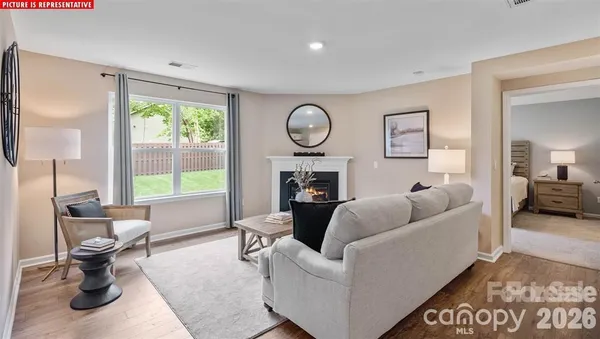 a living room with furniture a table and a large window
