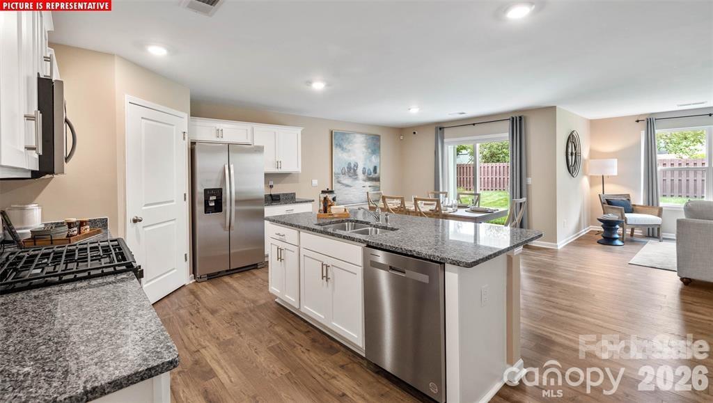 1700 Vanderlyn Street Monroe, NC 28112 - Photo 6 of 19 a kitchen with stainless steel appliances granite countertop a refrigerator a stove and a sink