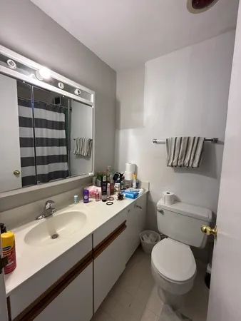 a bathroom with a toilet sink and mirror