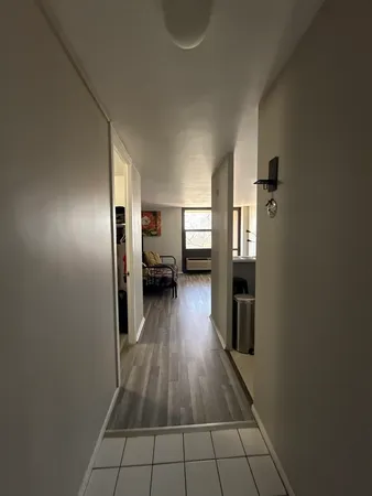 a view of a hallway view with wooden floor and electronic appliances