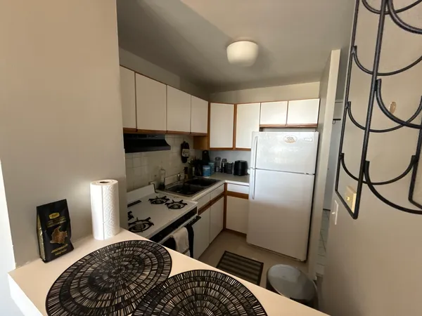 a kitchen with a refrigerator and a stove top oven