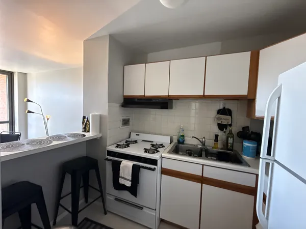 a kitchen with a sink a cabinets and appliances