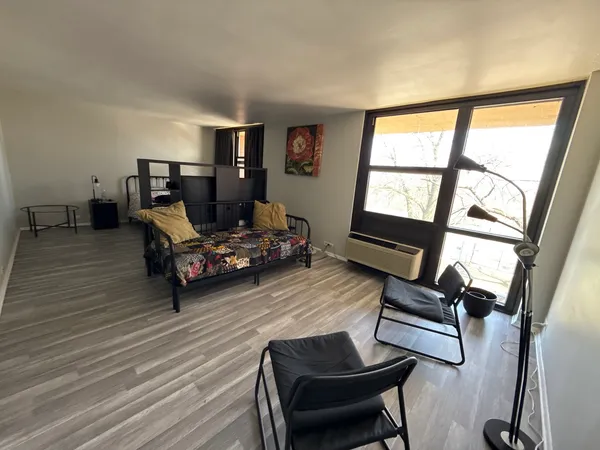 a living room with furniture and a floor to ceiling window