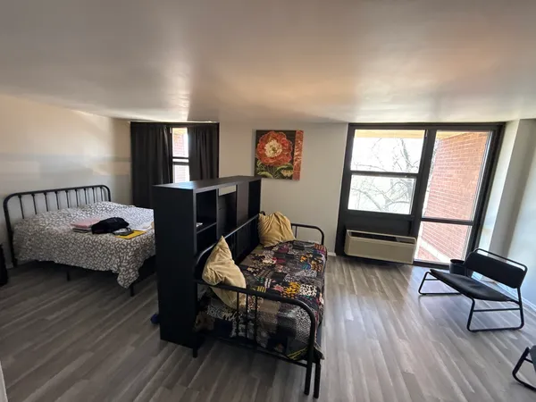 a bedroom with furniture and a window