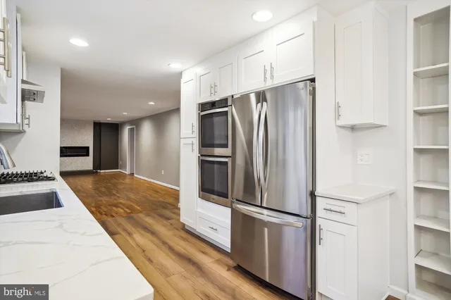 a kitchen with stainless steel appliances a refrigerator and a stove top oven