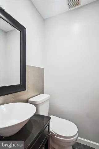a white toilet sitting next to a white sink