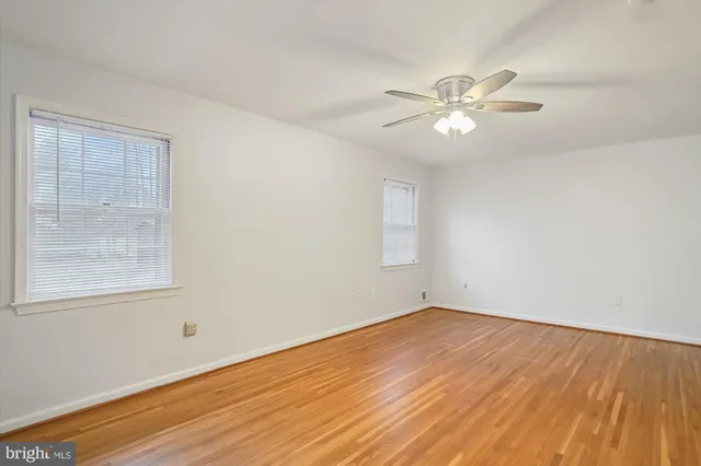 a bathroom with a granite countertop sink a toilet a mirror and shower