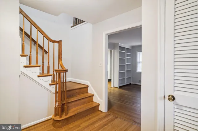 a view of entryway with wooden floor and stairs