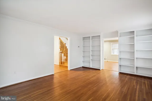 an empty room with wooden floor and closet