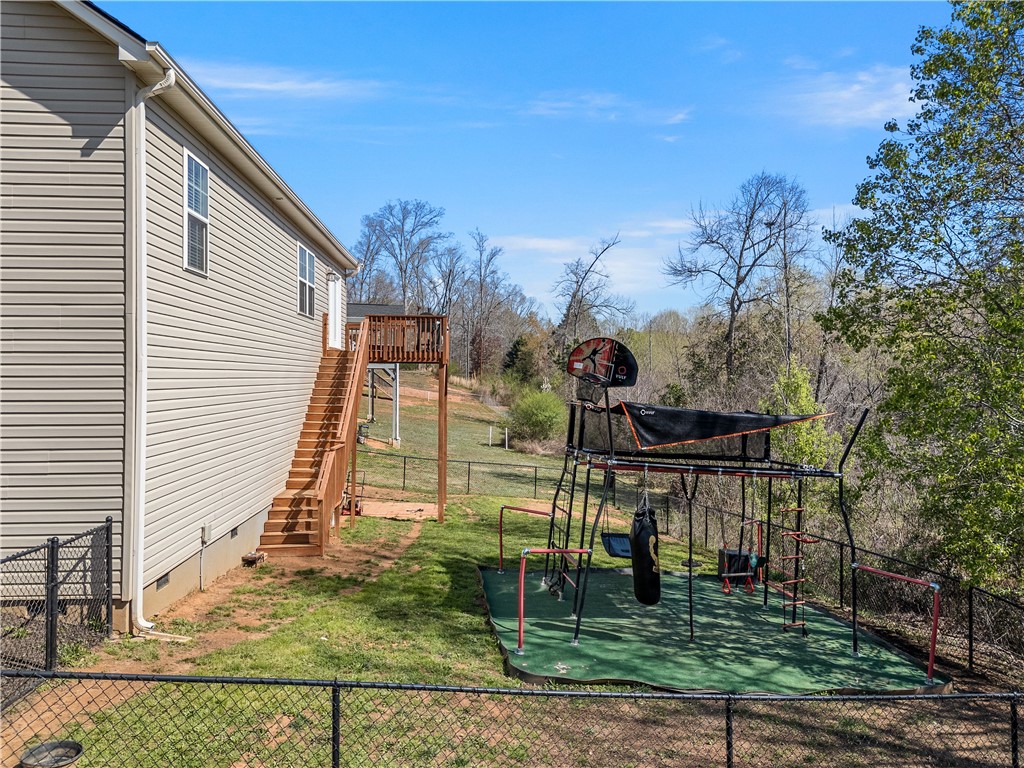 2520 Linmar Circle Anderson, SC 29621 - Photo 42 of 50 A fenced backyard offers ample space for outdoor activities and an elevated deck for relaxation.