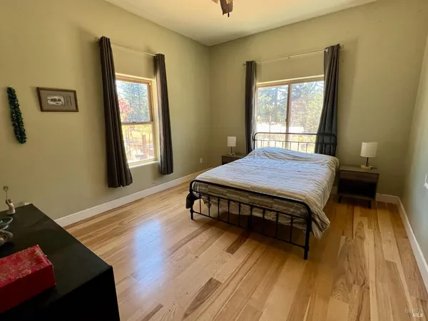 a bed sitting in a bedroom next to a window
