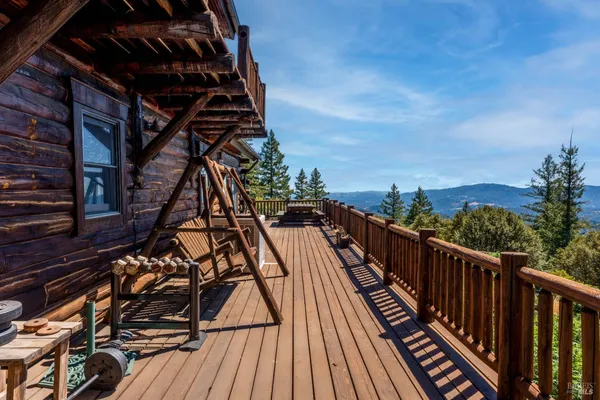 a view of balcony with wooden floor and fence