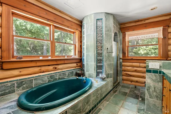 a bathroom with a tub and sink