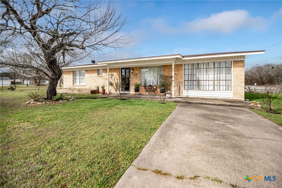 207 Williams Street Tivoli, TX 77990 - Photo 5 of 32 a front view of a house with a yard and trees