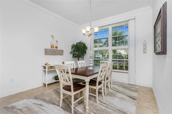 a view of a dining room with furniture wooden floor and chandelier
