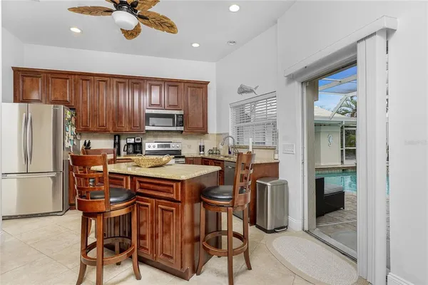a kitchen with stainless steel appliances granite countertop a stove and cabinets