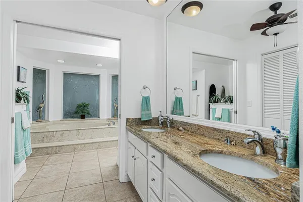 a bathroom with a granite countertop sink a toilet and a mirror