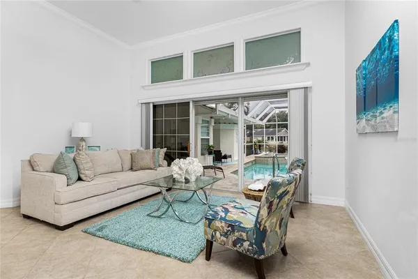 a living room with furniture and a chandelier