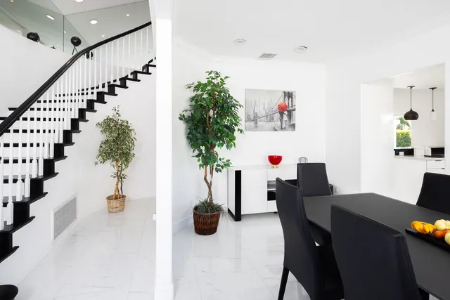 a living room with a flat screen tv and a potted plant