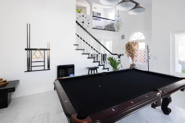a living room with furniture a flat screen tv and a large window