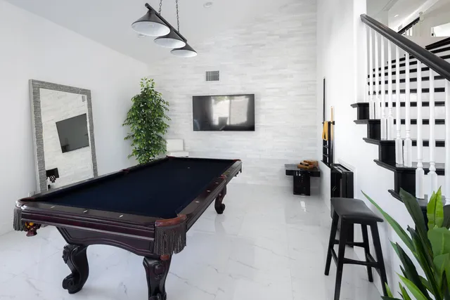 a kitchen with stainless steel appliances kitchen island a table and chairs in it