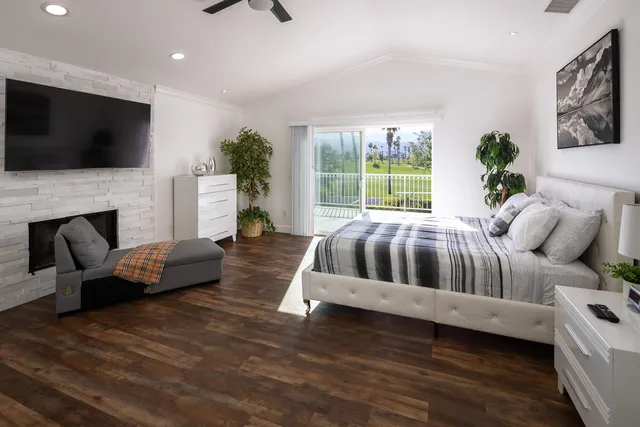 a bedroom with a bed and flat screen tv