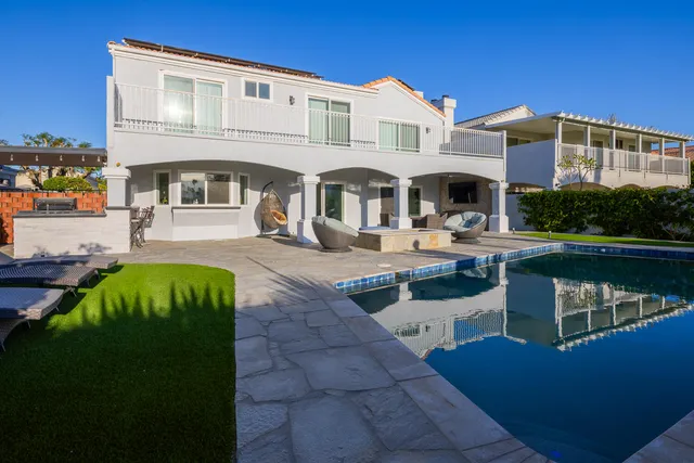 a view of a house with swimming pool and sitting area