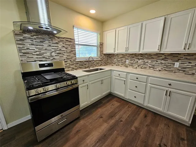 a kitchen with stainless steel appliances granite countertop a stove and a sink