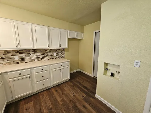 a view of kitchen with cabinets and wooden floor