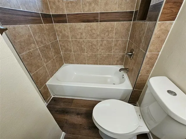 a bathroom with a toilet and a tub