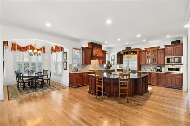 a dining room with wooden floor and a window