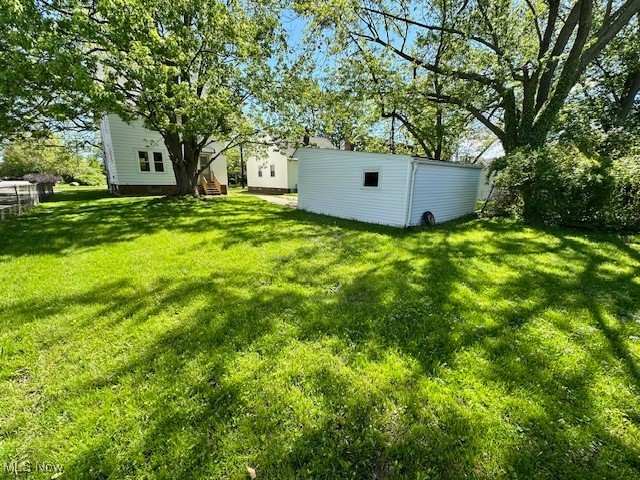 356 Babbitt Road Euclid, OH 44123 - Photo 4 of 18 View of green lawn with an outdoor structure and a storage shed