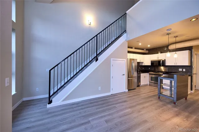 a view of kitchen with furniture and wooden floor