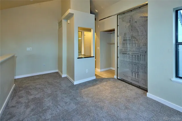 an empty room with a bathroom and shower